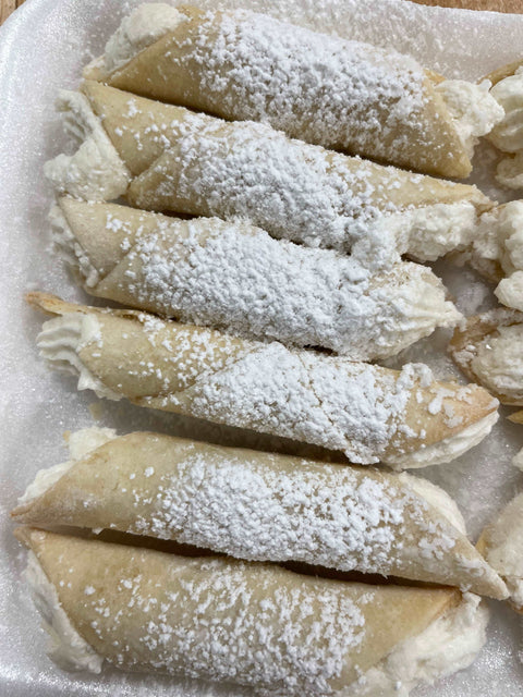 Cookies - Wedding Cookies with with cream oon a plate sprinkled with powdered sugar