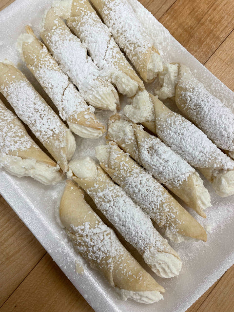 Cookies - Wedding Cookies with with cream oon a plate sprinkled with powdered sugar