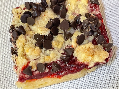 Raspberry Bar with crumble and chocolate chips on white background