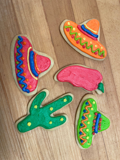 5 orange and red sombrero, cacti, chili pepper iced sugar cookies on a wood table 