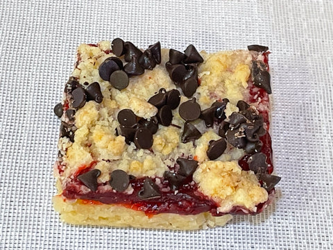 Raspberry Bar with crumble and chocolate chips on white background